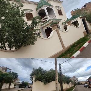 a white house with a window and a tree at Villa ben lahbib II in Khenifra