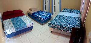a room with two beds and a bedskirts at Hostel New Brothers in Panajachel +7 photos