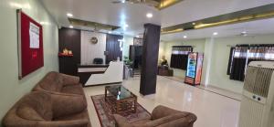 a lobby with two chairs and a table at Hotel Balaji Inn in Raipur