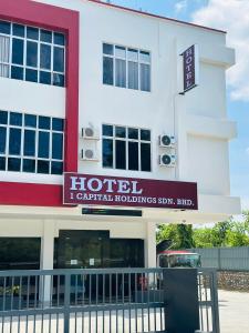 a hotel with a sign in front of a building at Get Inn Hotel at 1 Capital Holdings in Gua Sai