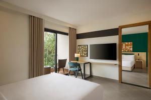 a hotel room with a bed and a desk at Spark By Hilton Goa Calangute in Goa +19 photos