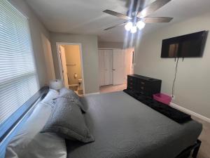 a bedroom with a bed and a ceiling fan at Greystone Ranch Pet Friendly in Clarksville