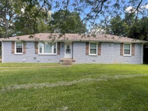 a white brick house with a grass yard at Greystone Ranch Pet Friendly in Clarksville