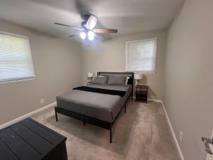 a bedroom with a bed and a ceiling fan at Greystone Ranch Pet Friendly in Clarksville