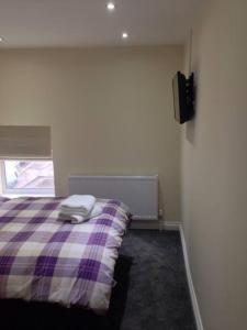 a bedroom with a bed with a pillow on it at Airport Tavern Accommodation in Felton