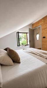a white bed with two pillows on top of it at mansarda roulette in Saint Vincent