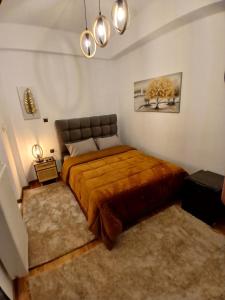 a bedroom with a large bed with a brown blanket at family home in Dimitsana