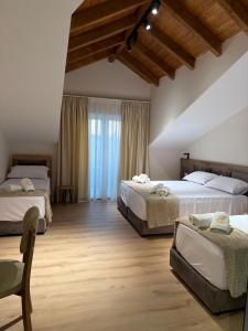 a bedroom with two beds and a large window at Grand Station Hotel in Shkodër +48 photos
