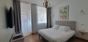a bedroom with a bed and a large window at Les Cabines in Houlgate +129 photos