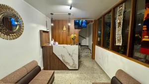 a living room with a couch and a counter at Apachetas Hotel in Machu Picchu