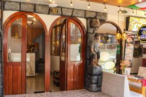 a store with a statue of a man standing in the doorway at Apachetas Hotel in Machu Picchu