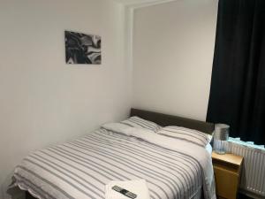 a bedroom with a bed with a book on it at Haven House in Hull