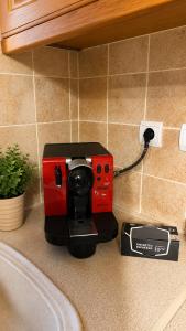 a coffee maker on a counter next to a charger at Pyrgos Traditional House in Pyrgi