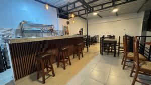 a restaurant with a bar with stools and a fish tank at Apachetas Hotel in Machu Picchu +34 photos