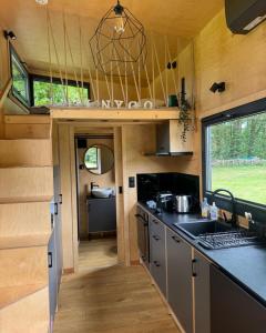 an interior view of a kitchen in a tiny house at Tiny House Porto op Domein Kiewit in Hasselt