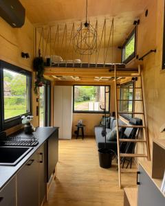 a tiny house with a loft bed in a kitchen at Tiny House Porto op Domein Kiewit in Hasselt