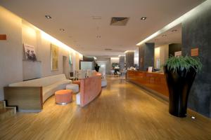 Die Eingangshalle eines Krankenhauses mit einer Couch und einem Tisch in der Unterkunft Hotel Major in Ronchi dei Legionari