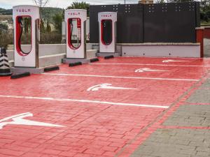 a parking lot with four red and white toilets at Ibis Girona in Girona