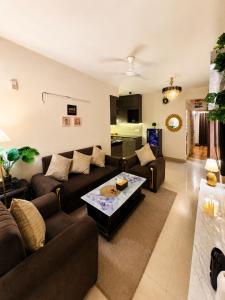 a living room with two couches and a coffee table at Ballentines Bliss in Babarpur