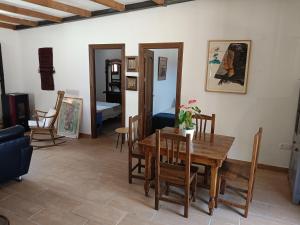 a living room with a wooden table and chairs at casita la bugamvilla in Mojácar