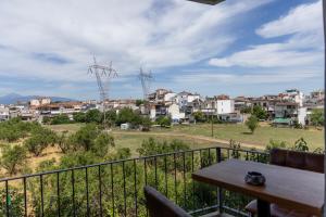 a balcony with a table and a view of a city at Elia mini suite 2 in Larisa