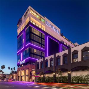 a building that is lit up in purple at Dream Hollywood, by Hyatt in Los Angeles