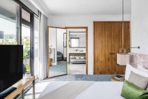 a living room with a television and a sliding door at Dream Hollywood, by Hyatt in Los Angeles +89 photos