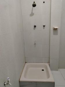 a white shower with a toilet in a bathroom at GD Guest in Bentota