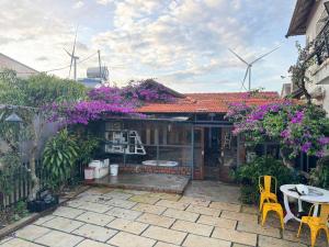 a house with a table and chairs and wind turbines at Mây inn' Cầu Đất - Homestay in Xuân Trường