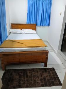 a bedroom with a wooden bed with a blue window at Kasi Heritage Home Near Sree Padmanabha Swami Temple 800m in Trivandrum