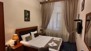 a hotel room with a bed and a window at Porto Bistro in Baku