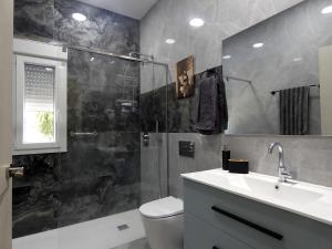 a bathroom with a shower and a sink and a toilet at Estación 87 Smart Workation y Relax Mediterráneo in Peniscola +20 photos