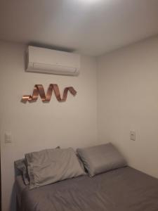 a bedroom with a bed and a air conditioner on the wall at Gravatá Winterville Residence in Gravatá +114 photos