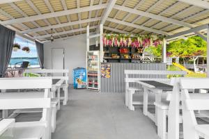 a white restaurant with white tables and benches at Fiesta in Solotvyno