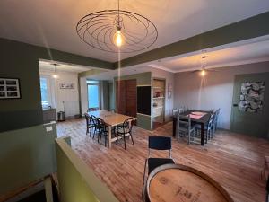 a kitchen and dining room with a table and chairs at Le Kompost'l chambre en gîte 2 pers in Saint-Privat-dʼAllier