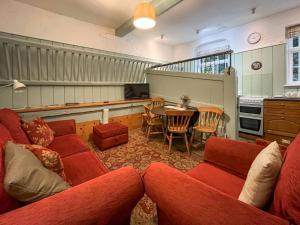 a living room with a red couch and a table at Stables - Uk51018 in Louth