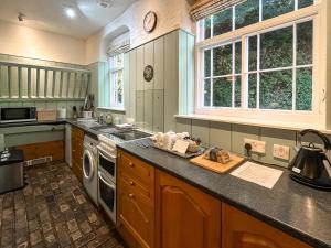 a kitchen with a sink and a stove top oven at Stables - Uk51018 in Louth +9 photos
