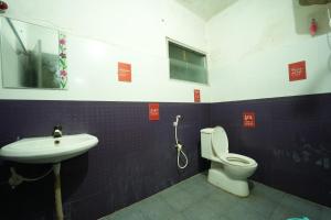 a bathroom with a toilet and a sink at Secret Ashram Coorg in Kushālnagar
