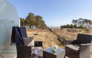 two chairs and a table with a view of a field at Skipper in Binz