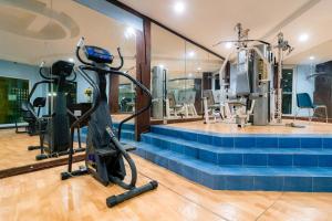 a gym with treadmills and elliptical machines at Crown Regency Residences Davao in Davao City