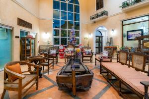 a room with tables and chairs and a christmas tree at Crown Regency Residences Davao in Davao City