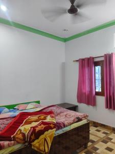 a bedroom with a bed and a ceiling at R K Hotel & HELY ROOMS in Phata