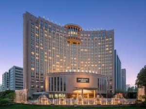 a large building with a fountain in front of it at Pullman Beijing South - Newly Renovated in Beijing