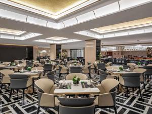 a large dining room with tables and chairs at Pullman Beijing South - Newly Renovated in Beijing