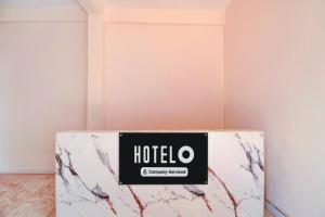 a room with a hotel sign on the wall at Super Hotel O Dehu Pune Formerly Gathaa Inn in Dehu