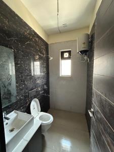 a bathroom with a white toilet and a sink at Balaji villa in Juliāsar