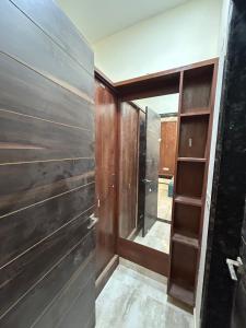 a room with wooden walls and a door and a shelf at Balaji villa in Juliāsar