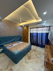 a bedroom with a bed in a room with a ceiling at Balaji villa in Juliāsar