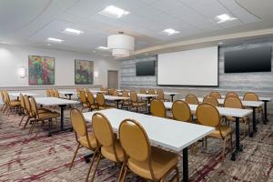 a conference room with tables and chairs and a whiteboard at Hilton Garden Inn Wayne in Wayne
