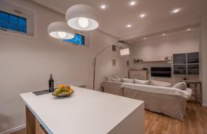 a kitchen and living room with a table and a couch at Hyacinth House in Tbilisi City